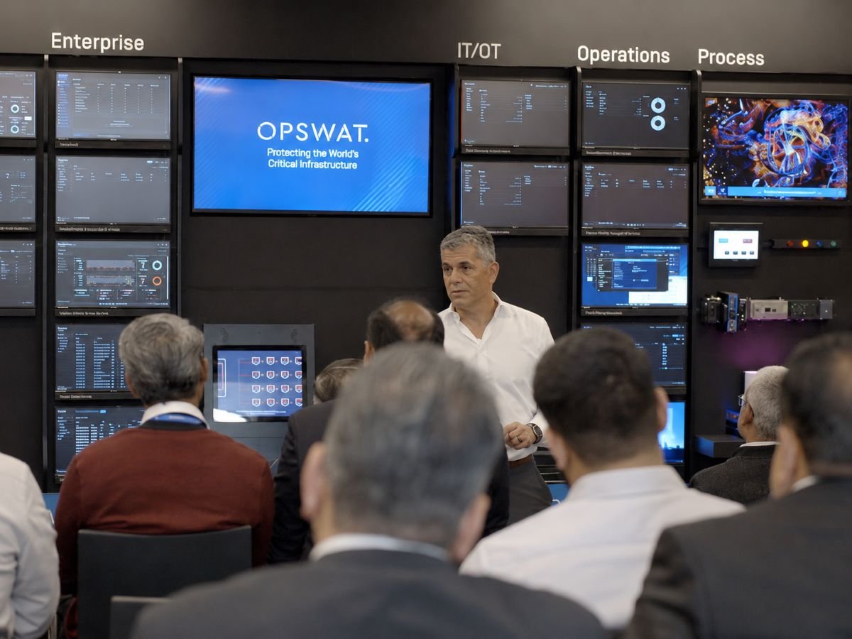 OPSWAT team presenting critical infrastructure protection dashboards
